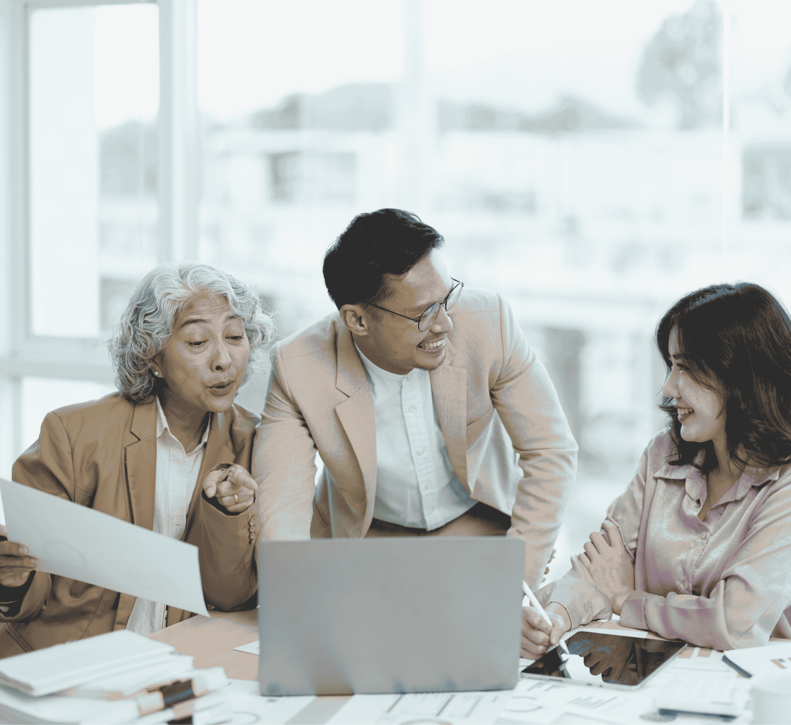 Employees from different generations discussing work in an office meeting