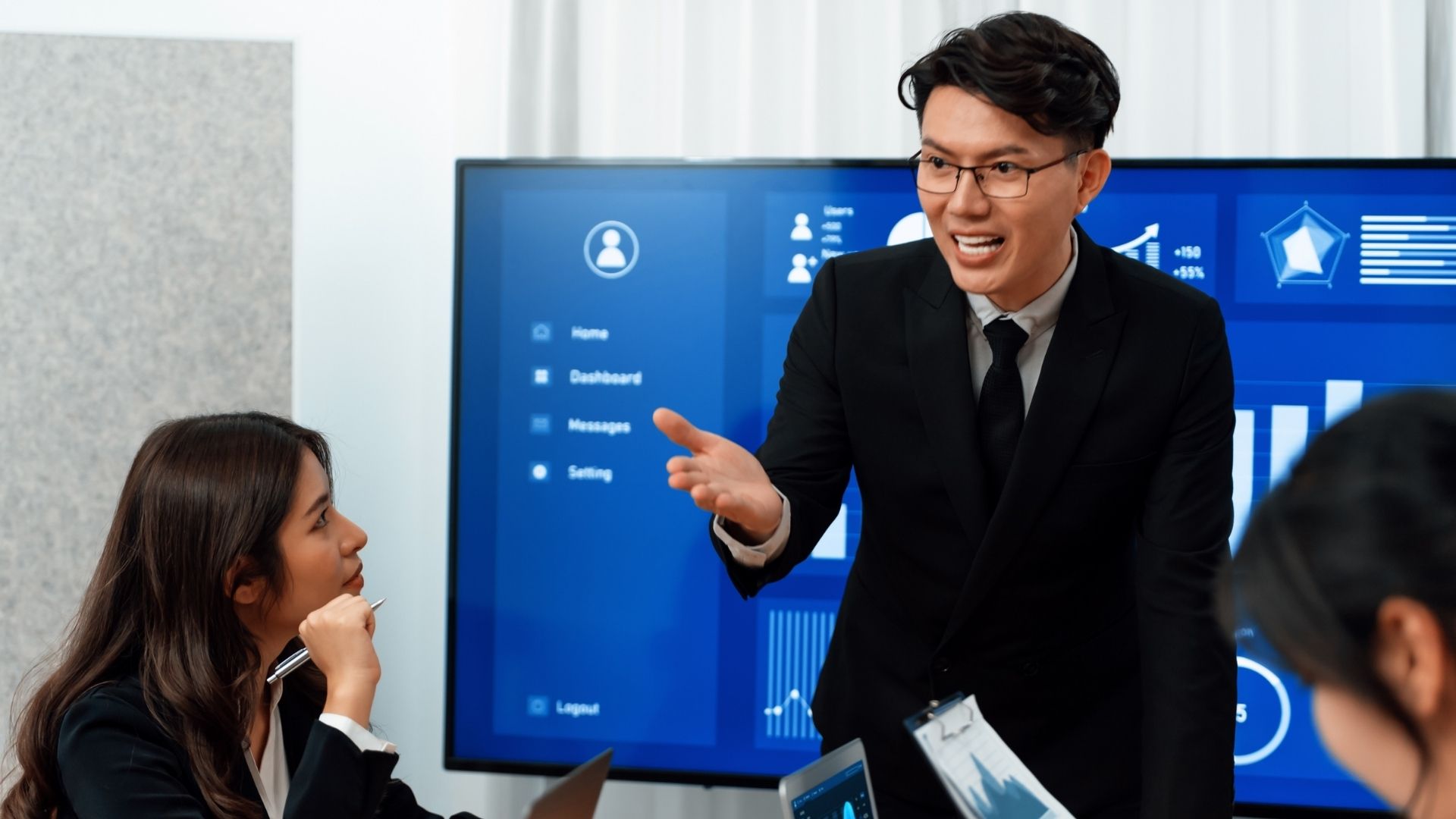 Business leader discussing AI strategy and governance with colleagues during a team meeting.